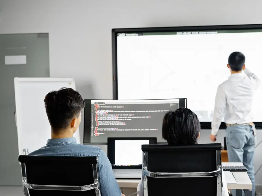 Eranova engineers reviewing code during a deployment