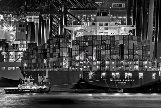 A container ship at port at night