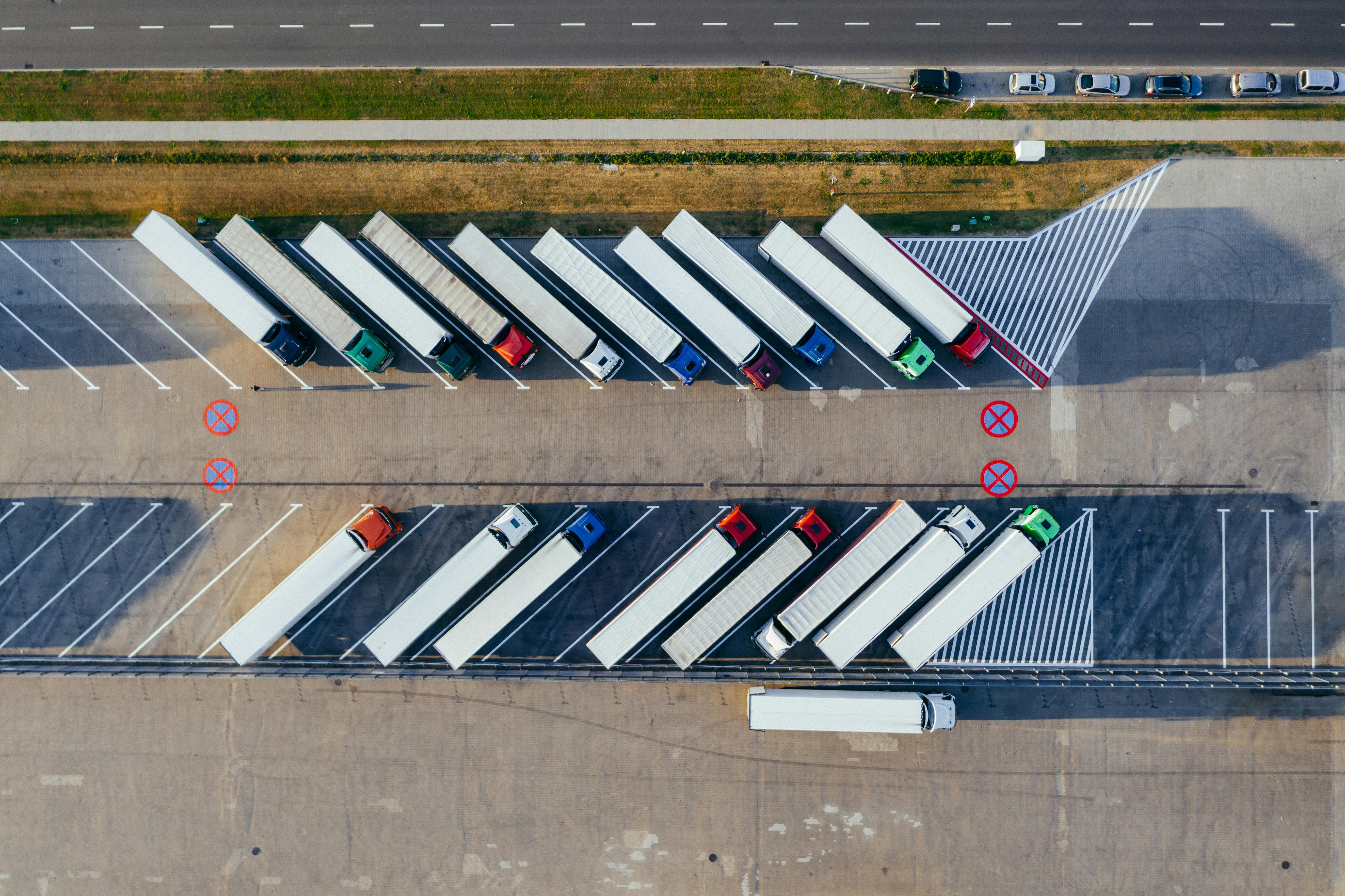 Aerial view of semi-trucks lined up at a logistics yard