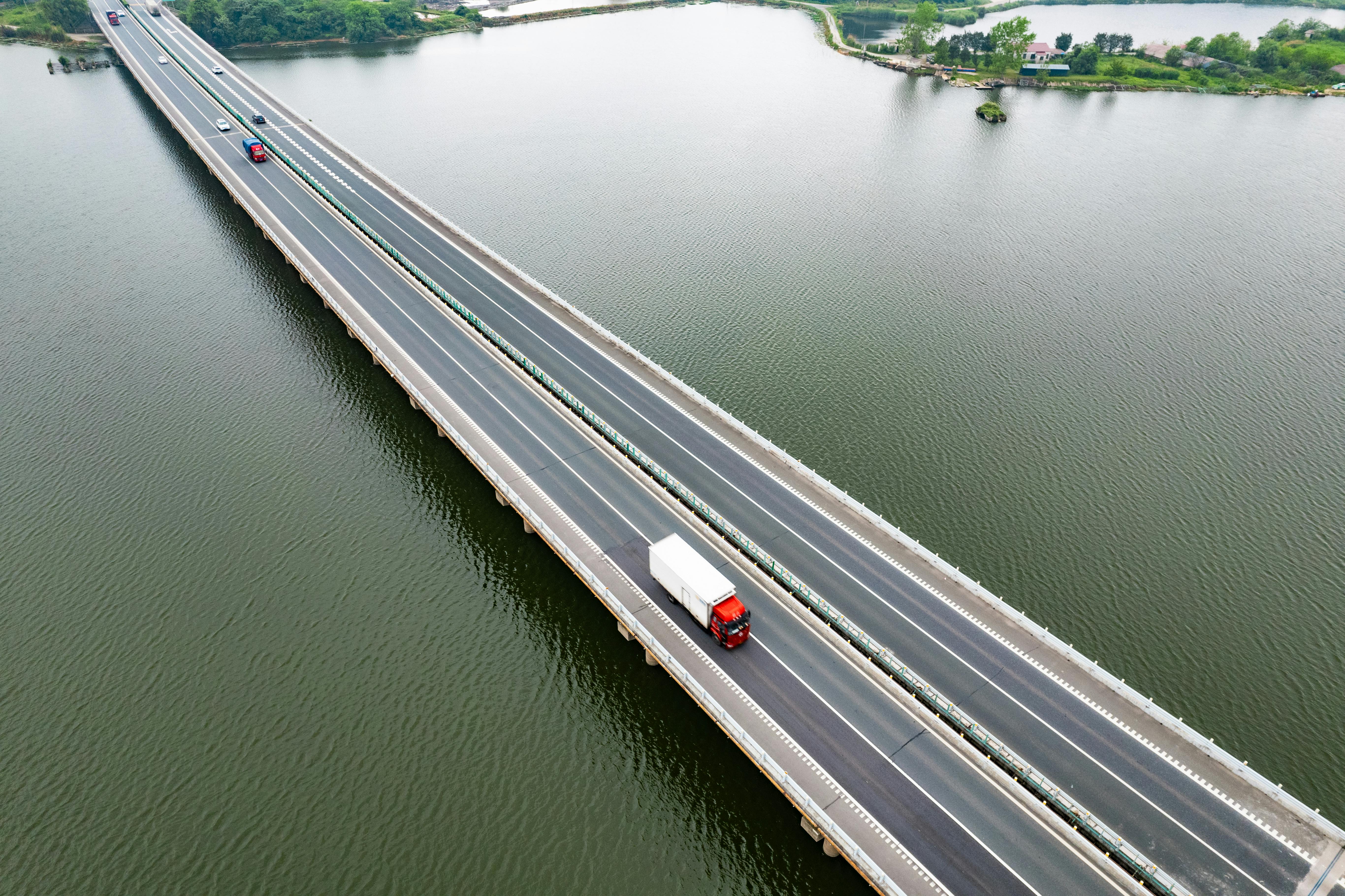 Freight trucks crossing a bridge over water