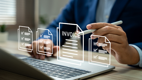 Finance leader reviewing invoices with AI assistance